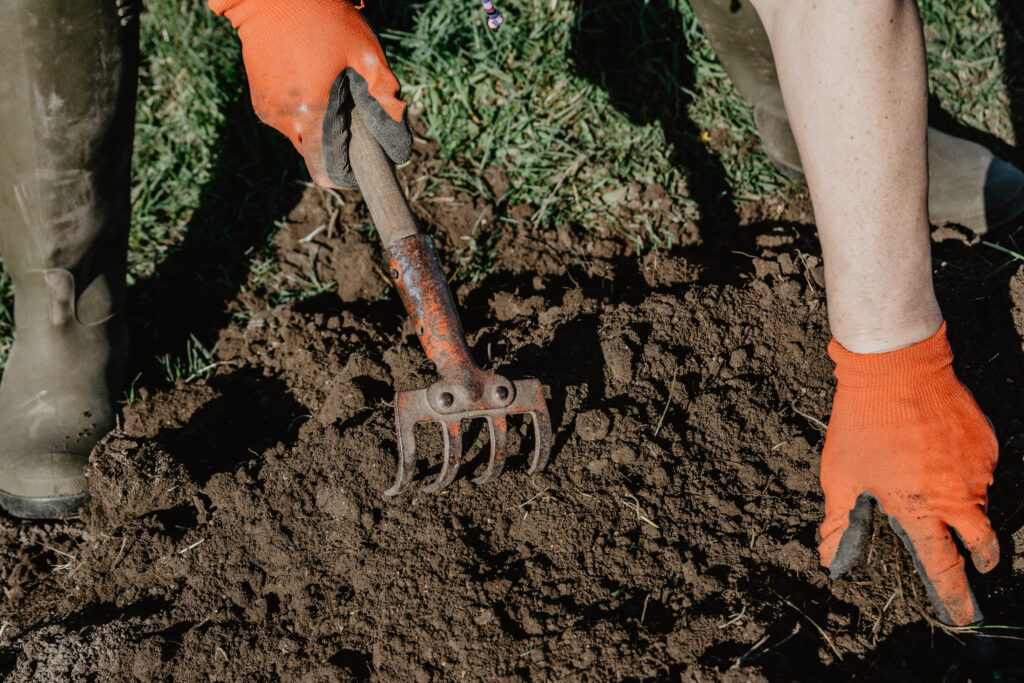 Preparing soil by hand to improve plant food elements and macronutrient balance