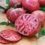 Heirloom tomato sliced to show rich color and texture – grown from open pollinated garden seeds